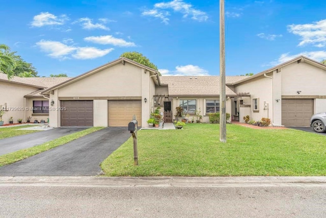 ranch-style house featuring a garage and a front lawn