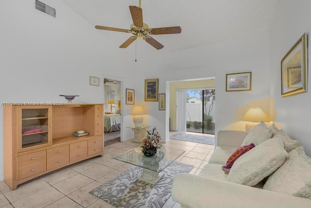 tiled living room featuring high vaulted ceiling and ceiling fan