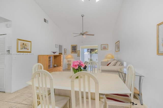 dining room with high vaulted ceiling, light tile patterned floors, and ceiling fan