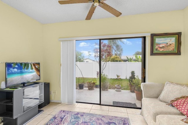 tiled living room with a healthy amount of sunlight, a textured ceiling, and ceiling fan