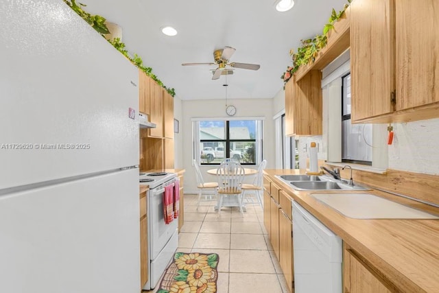 kitchen with sink, light tile patterned flooring, white appliances, and ceiling fan