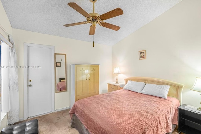 bedroom featuring ceiling fan, a textured ceiling, light carpet, and lofted ceiling