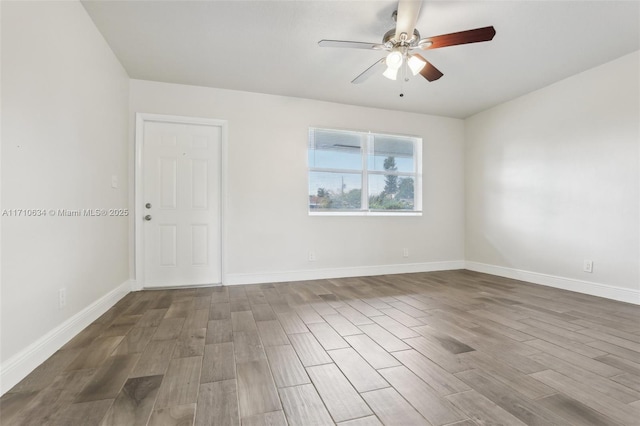 spare room with ceiling fan and wood-type flooring