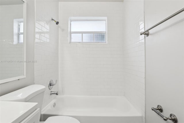 full bathroom with toilet, vanity, and tiled shower / bath