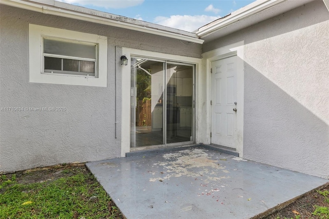 doorway to property with a patio