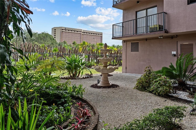 view of yard with a balcony