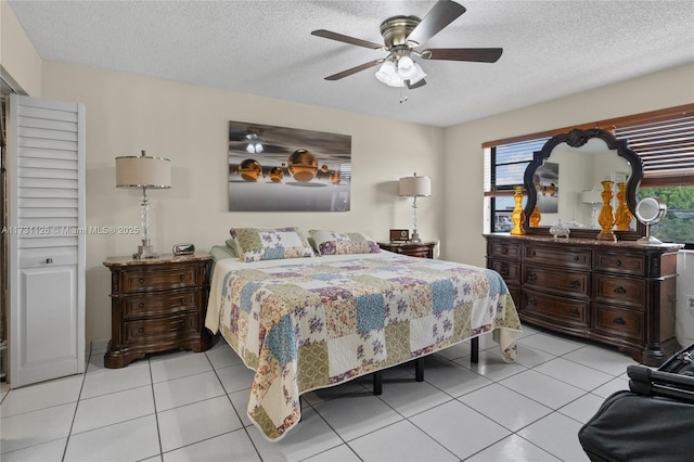 bedroom featuring light tile patterned flooring, a textured ceiling, and ceiling fan