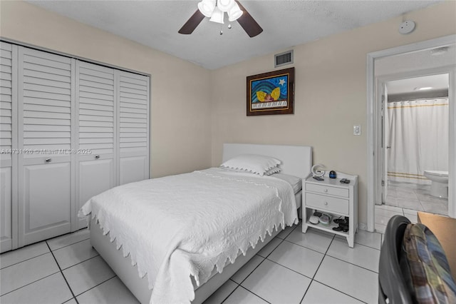 bedroom with a closet, ceiling fan, a textured ceiling, and light tile patterned flooring