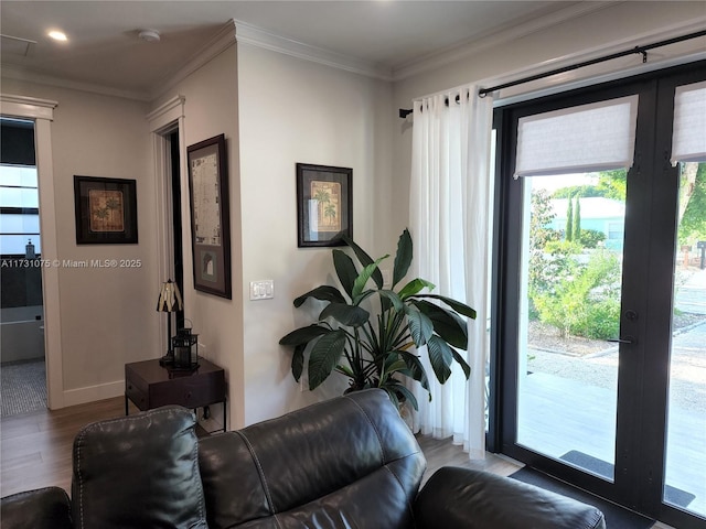 living room with hardwood / wood-style flooring and ornamental molding