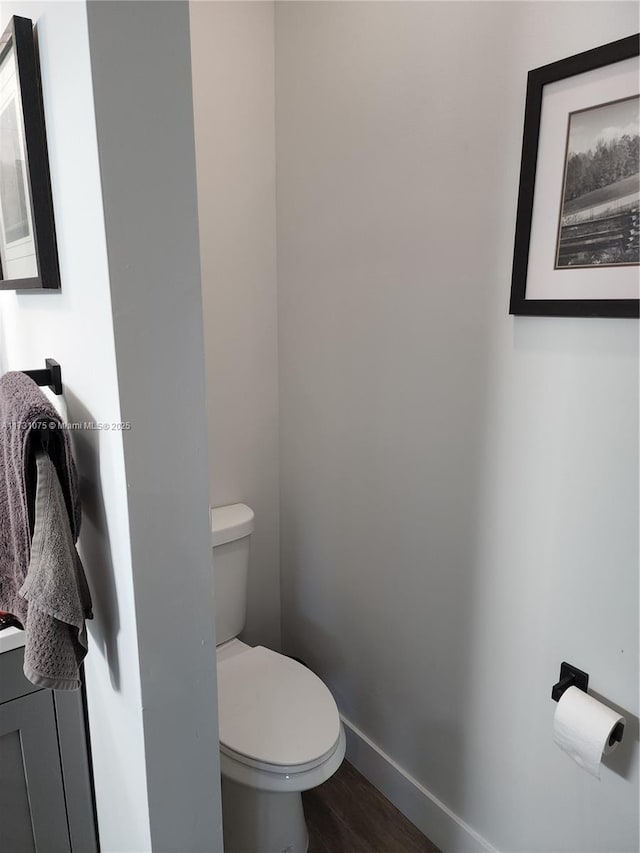 bathroom with hardwood / wood-style floors and toilet