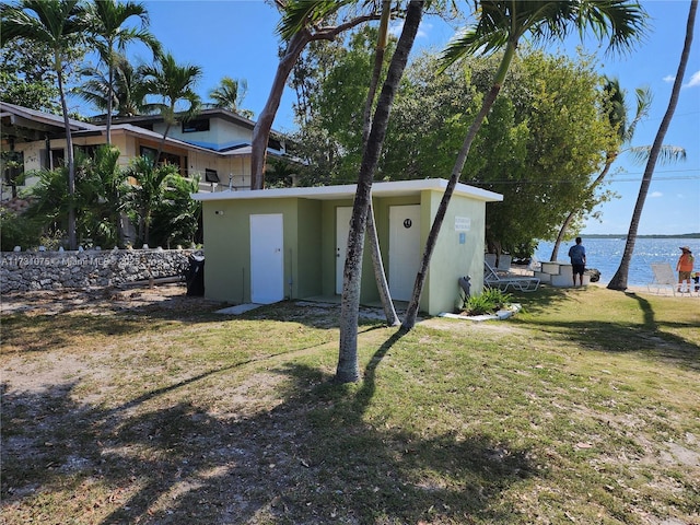 exterior space featuring a water view and a lawn