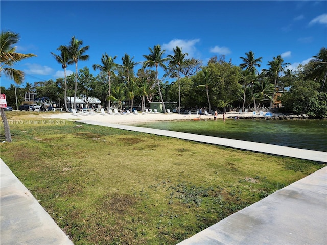 view of community featuring a lawn and a water view