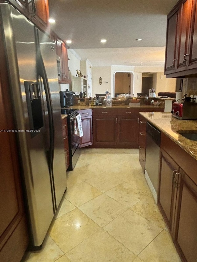 kitchen featuring kitchen peninsula, light stone counters, light tile patterned floors, and appliances with stainless steel finishes