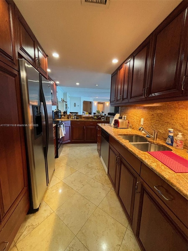 kitchen featuring electric range, backsplash, stainless steel dishwasher, refrigerator with ice dispenser, and a sink