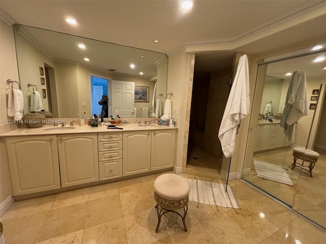 full bath with double vanity, ornamental molding, a sink, and recessed lighting