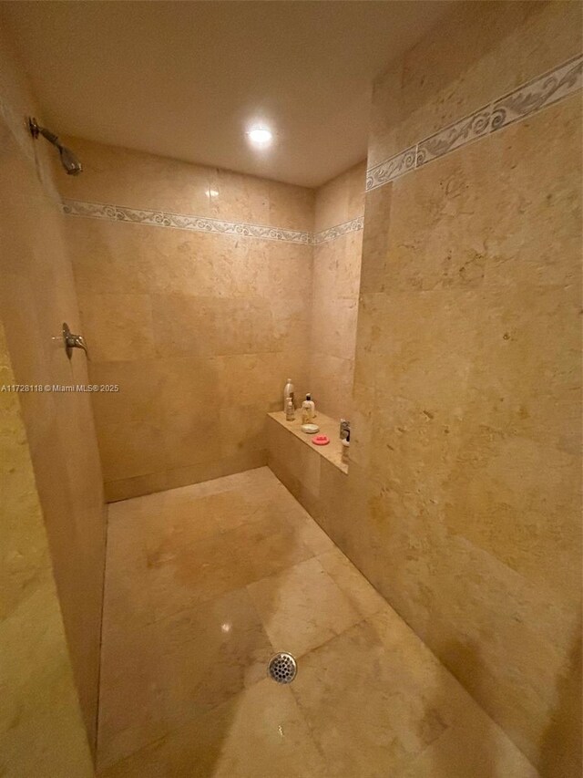 bathroom featuring a shower with shower door, tile patterned floors, vanity, and crown molding