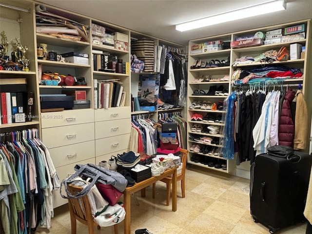 walk in closet with light floors