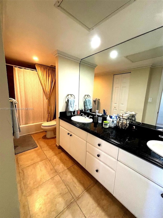 bathroom featuring double vanity, shower / tub combo, a sink, and toilet