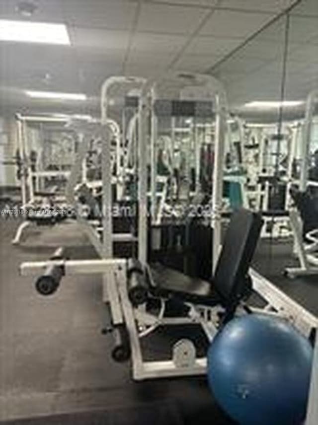 workout area featuring a paneled ceiling