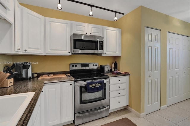 kitchen featuring sink, light tile patterned floors, white cabinets, and stainless steel appliances