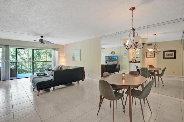 dining room featuring ceiling fan with notable chandelier, a textured ceiling, and light tile patterned flooring