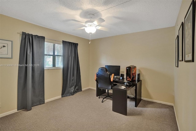 carpeted home office featuring ceiling fan and a textured ceiling