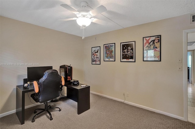 carpeted home office featuring ceiling fan and a textured ceiling