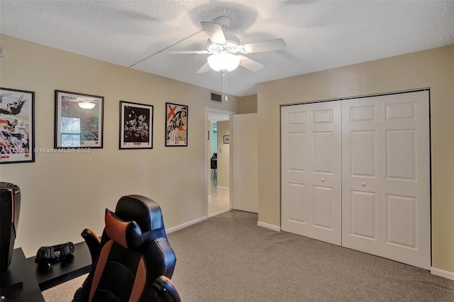 office area featuring ceiling fan and a textured ceiling