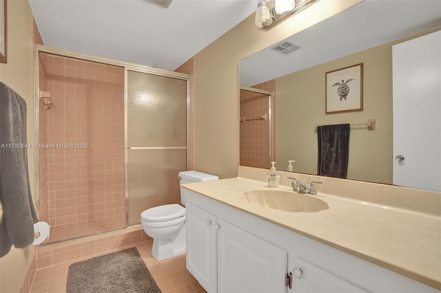 bathroom with toilet, vanity, an enclosed shower, and tile patterned flooring