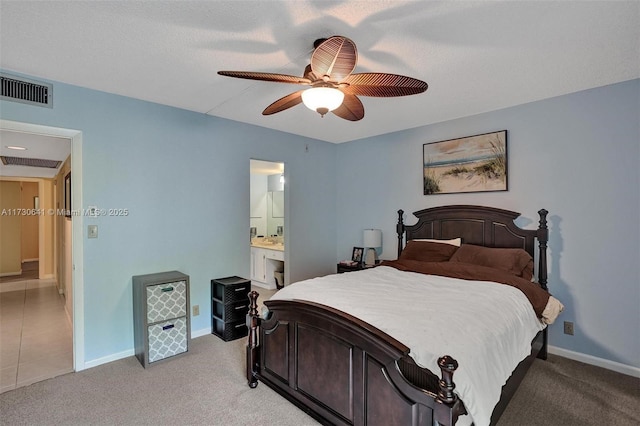 carpeted bedroom featuring ceiling fan and ensuite bath