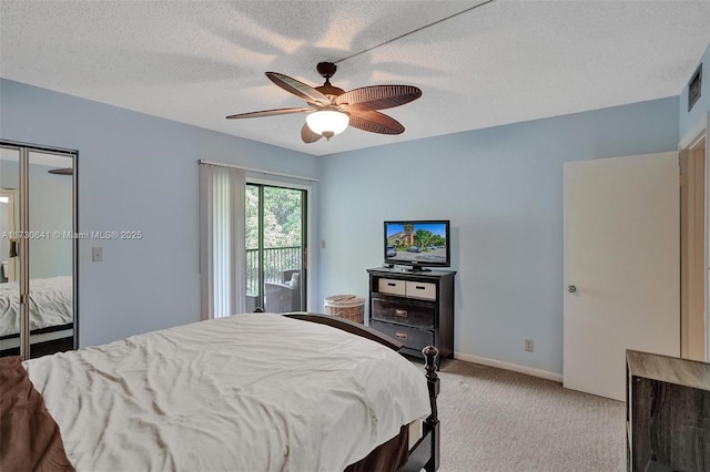 carpeted bedroom with ceiling fan, access to outside, and a textured ceiling