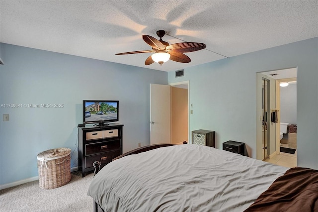 carpeted bedroom with ceiling fan and a textured ceiling