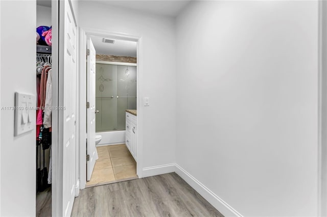 corridor featuring light hardwood / wood-style floors