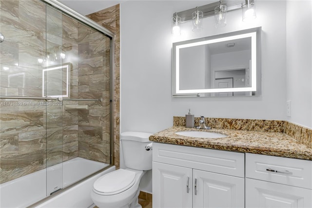 full bathroom with toilet, vanity, and combined bath / shower with glass door