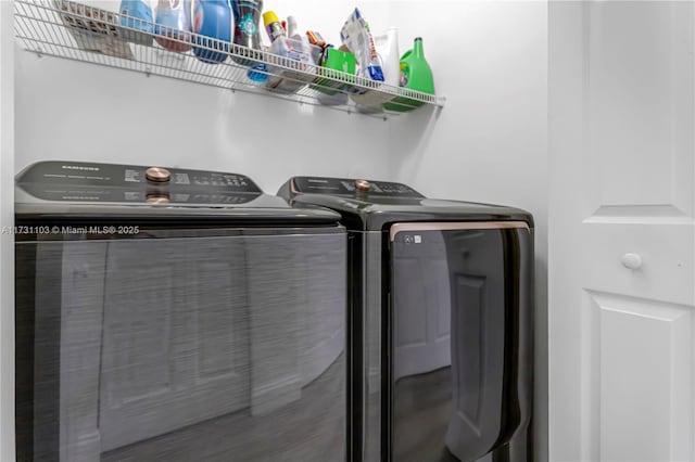 clothes washing area with separate washer and dryer