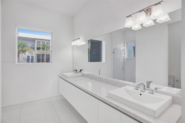 bathroom with vanity, toilet, a shower with shower door, and tile patterned flooring