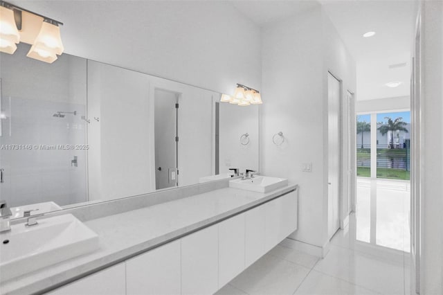 bathroom featuring walk in shower, vanity, and tile patterned flooring