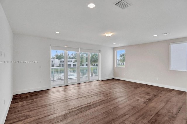 empty room featuring dark hardwood / wood-style flooring