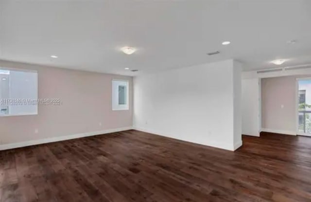 empty room featuring dark wood-type flooring