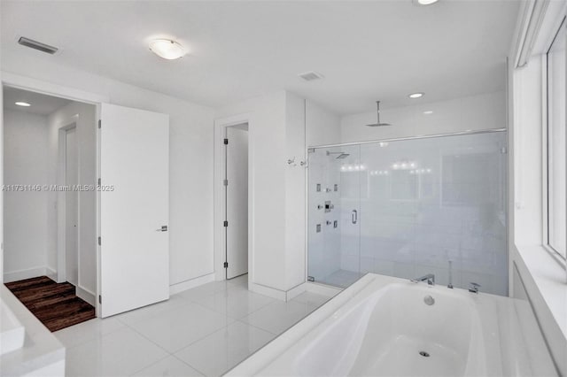 bathroom with tile patterned flooring and independent shower and bath