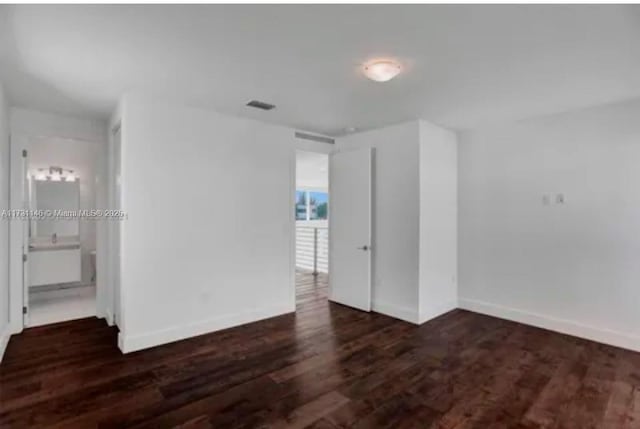 unfurnished room featuring dark hardwood / wood-style flooring