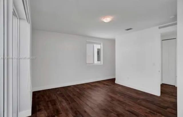 unfurnished bedroom featuring dark hardwood / wood-style floors