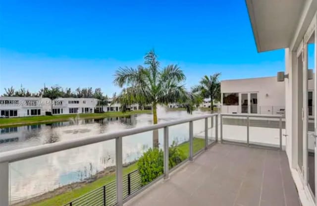 balcony featuring a water view