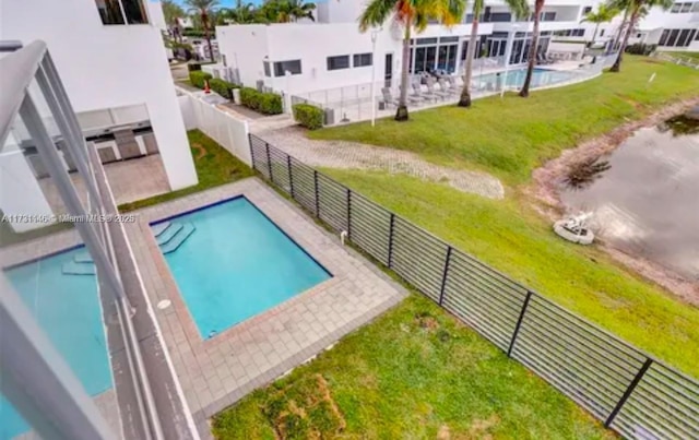 view of swimming pool with a lawn