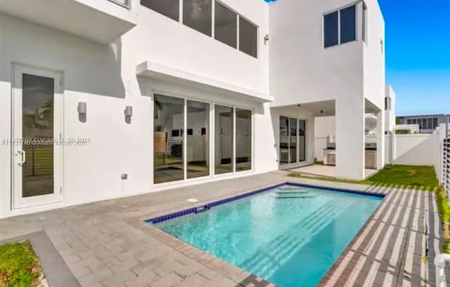 rear view of property featuring a patio