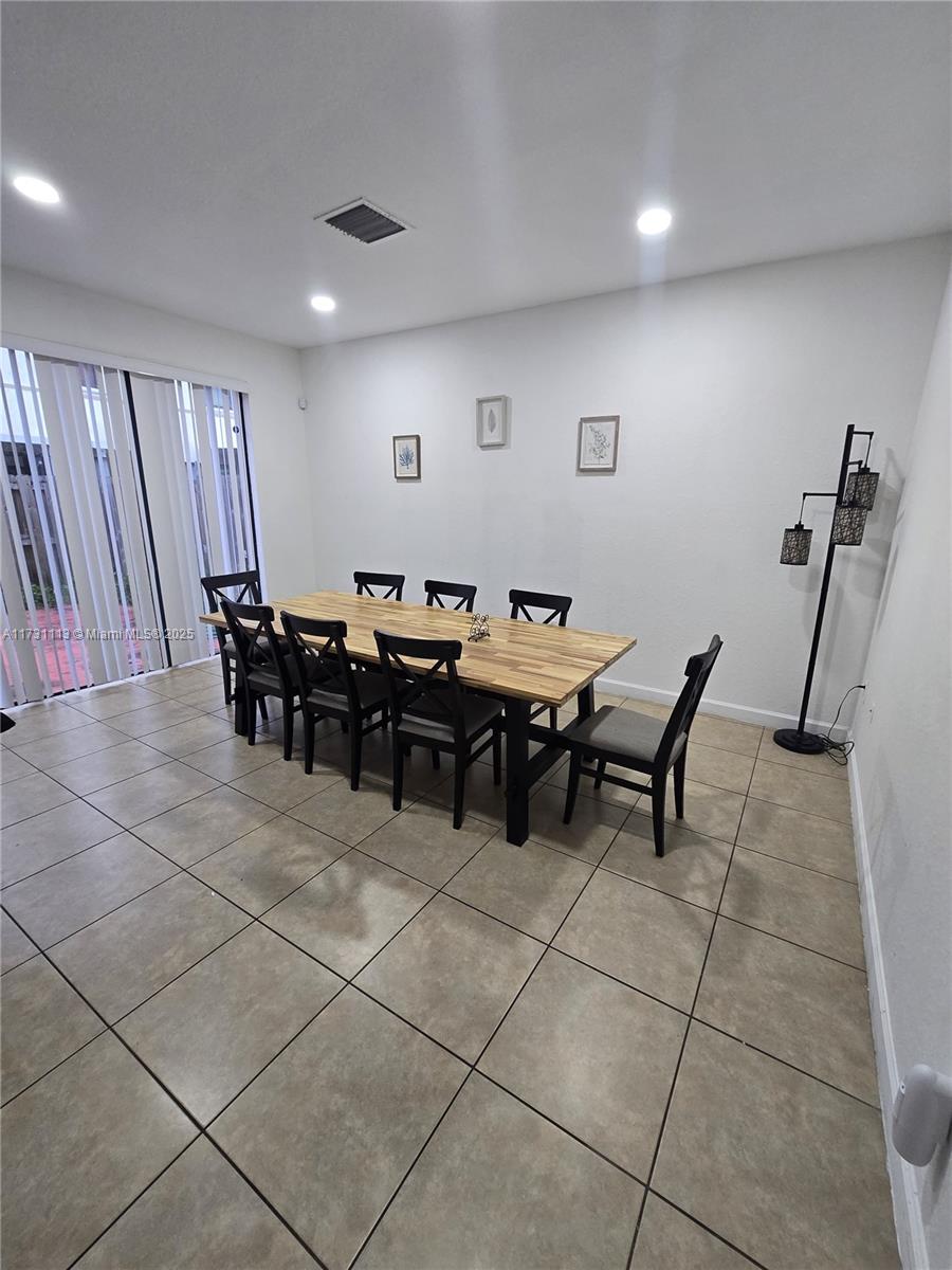 dining space featuring light tile patterned flooring