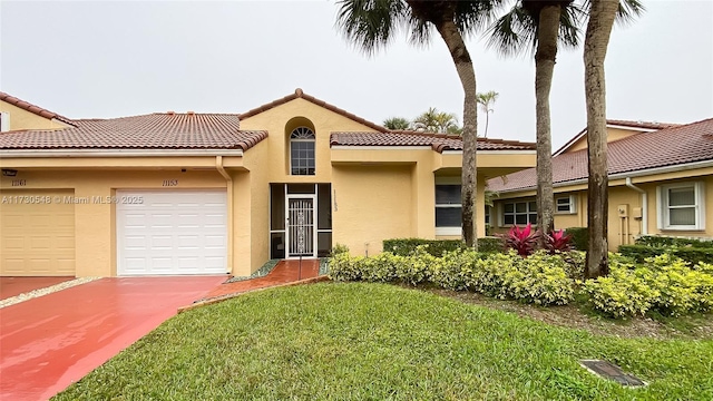 mediterranean / spanish home featuring a garage and a front lawn