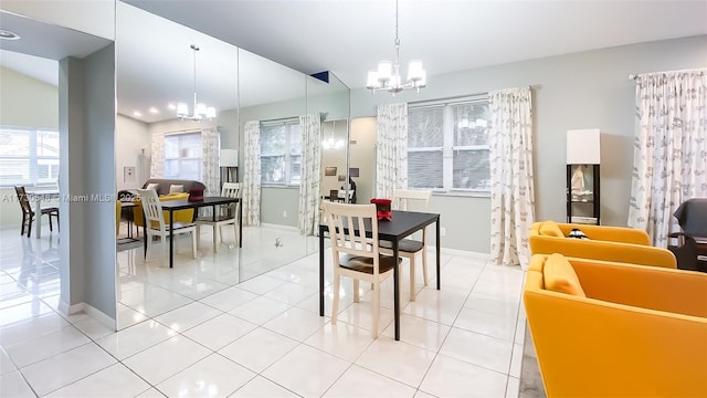 dining space featuring light tile patterned floors and a notable chandelier