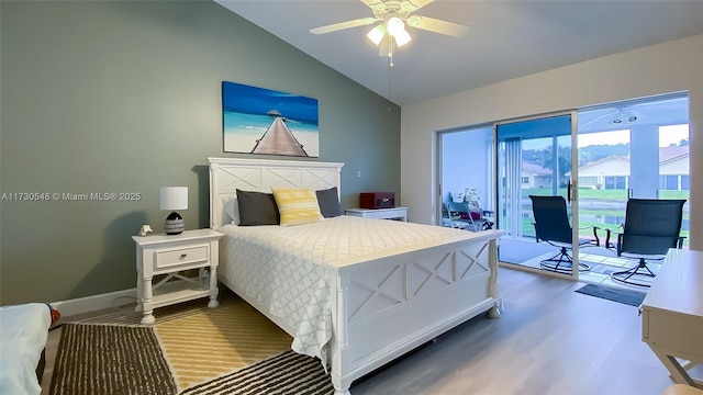 bedroom with ceiling fan, access to exterior, wood-type flooring, and vaulted ceiling