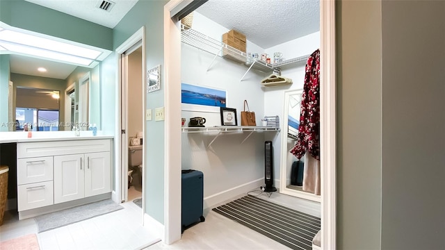 bathroom featuring vanity, toilet, and a textured ceiling